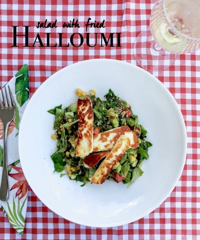 salad topped with fried halloumi